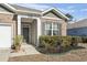 Charming home entrance with brick facade, gray shutters, and a well-manicured front yard at 156 Legends Village Loop, Myrtle Beach, SC 29579