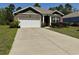 Charming home featuring a two-car garage, brick accents, and a well-maintained lawn at 156 Legends Village Loop, Myrtle Beach, SC 29579