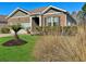 Charming single-story home featuring a brick facade, landscaped front yard, and a well-manicured lawn at 156 Legends Village Loop, Myrtle Beach, SC 29579