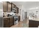 Modern kitchen featuring granite countertops, stainless steel appliances, and dark wood cabinetry at 156 Legends Village Loop, Myrtle Beach, SC 29579