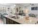 Kitchen island featuring granite countertops, a sink, and seating, with an adjacent dining area at 156 Legends Village Loop, Myrtle Beach, SC 29579
