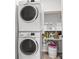 Convenient laundry room featuring stacked washer and dryer and storage shelves at 156 Legends Village Loop, Myrtle Beach, SC 29579