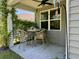 Charming covered patio with wicker seating and climbing vines, offering a relaxing outdoor space at 156 Legends Village Loop, Myrtle Beach, SC 29579
