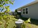 A view of the backyard with a covered patio and gray vinyl siding at 156 Legends Village Loop, Myrtle Beach, SC 29579
