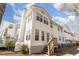 Back exterior of the home with wooden deck and stairs leading down to the yard at 157 Egret Run Ln. # 522, Pawleys Island, SC 29585