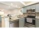 Well-lit kitchen with stainless steel appliances, sink, faucet, and granite countertops at 157 Egret Run Ln. # 522, Pawleys Island, SC 29585