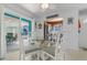 Bright dining room with glass table, seating for four, and sliding door to covered patio at 1607 Havens Dr., North Myrtle Beach, SC 29582