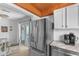 Kitchen with stainless steel fridge and view into the dining room and sliding glass door access at 1607 Havens Dr., North Myrtle Beach, SC 29582