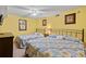 Bedroom featuring two beds, ceiling fan and yellow painted walls at 1625 S Ocean Blvd. # 403, North Myrtle Beach, SC 29582