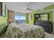 Bright bedroom with ocean view balcony, ceiling fan and green walls create a relaxing atmosphere at 1625 S Ocean Blvd. # 403, North Myrtle Beach, SC 29582