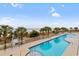 Outdoor pool with surrounding palm trees offering ocean views and relaxation at 1625 S Ocean Blvd. # 403, North Myrtle Beach, SC 29582