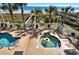 Community hot tub and pool area surrounded by palm trees with beach access at 1625 S Ocean Blvd. # 403, North Myrtle Beach, SC 29582