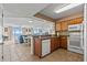 Open kitchen with granite countertops, white appliances, and a view to the living area at 1625 S Ocean Blvd. # 403, North Myrtle Beach, SC 29582