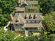 Aerial view of a home with a covered porch, surrounded by lush greenery and mature trees at 201 Broad St., Georgetown, SC 29440