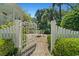 Inviting backyard entrance featuring a wrought iron gate, and manicured landscaping at 201 Broad St., Georgetown, SC 29440