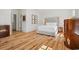 Bright bedroom with hardwood floors, a tufted headboard, and matching bedside tables at 201 Broad St., Georgetown, SC 29440