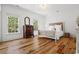 Sunlit bedroom featuring hardwood floors, white walls, and two windows offering lush green views at 201 Broad St., Georgetown, SC 29440