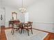 Formal dining room boasts hardwood floors, chandelier, and decorative rug, perfect for entertaining at 201 Broad St., Georgetown, SC 29440