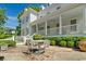 Beautiful white home exterior featuring a quaint patio area with a table and chairs for outdoor relaxation at 201 Broad St., Georgetown, SC 29440