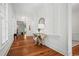 Bright foyer features hardwood flooring, decorative table, mirror, and wainscotting along the walls at 201 Broad St., Georgetown, SC 29440