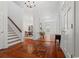 Bright foyer with beautiful hardwood floors and detailed trim, leading to a grand staircase and dining area at 201 Broad St., Georgetown, SC 29440