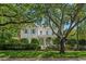 Beautiful two-story home with mature trees, lush lawn, and a welcoming front porch at 201 Broad St., Georgetown, SC 29440