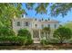 Charming white two-story home with gray shutters and a welcoming front porch surrounded by manicured landscaping at 201 Broad St., Georgetown, SC 29440