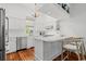 Well-lit kitchen with modern appliances, white cabinetry, breakfast bar, and hardwood floors at 201 Broad St., Georgetown, SC 29440