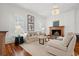 Bright living room features a fireplace, chandelier, hardwood floors, and neutral furniture at 201 Broad St., Georgetown, SC 29440