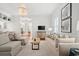 Bright, open-concept living area flows into dining area featuring hardwood flooring and neutral decor at 201 Broad St., Georgetown, SC 29440