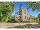 Elegant home showcasing a brick chimney, multiple porches, and lush landscaping at 201 Broad St., Georgetown, SC 29440