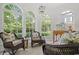 Inviting sunroom with large windows, comfortable wicker furniture, and tile flooring at 201 Broad St., Georgetown, SC 29440