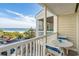 Balcony with seating and table overlooks beach, ocean and surrounding community at 210 North Ocean Blvd. # 330, North Myrtle Beach, SC 29582