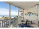 Relaxing balcony featuring ocean views, seating, and charming decorative touches at 210 North Ocean Blvd. # 330, North Myrtle Beach, SC 29582