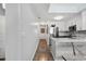 Hallway with a decorative rug that leads into the kitchen with stainless steel appliances at 210 North Ocean Blvd. # 330, North Myrtle Beach, SC 29582