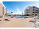 Community pool with lounge chairs surrounded by multi-story residential buildings at 210 North Ocean Blvd. # 330, North Myrtle Beach, SC 29582