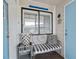 Charming porch area with a decorative bench, flower pot, and a blue door at 210 North Ocean Blvd. # 330, North Myrtle Beach, SC 29582