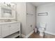 Well-lit bathroom featuring a vanity with a marble countertop, toilet, and hardwood floors at 2100 Sea Mountain Hwy. # 122, North Myrtle Beach, SC 29582