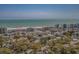 Aerial view of townhomes by the ocean, with mature trees and blue skies in the background at 218 Landing Rd. # G, North Myrtle Beach, SC 29582