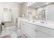 Bright bathroom featuring a double sink vanity, a large mirror, white cabinetry, and tile flooring at 2241 Waterview Dr. # 527, North Myrtle Beach, SC 29582