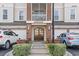 A welcoming condo entrance featuring a brick facade, double doors, manicured greenery, and garages at 2241 Waterview Dr. # 527, North Myrtle Beach, SC 29582