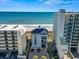 Beachfront property showcasing the building's facade, with a glimpse of the ocean and surrounding palm trees at 2241 Waterview Dr. # 527, North Myrtle Beach, SC 29582