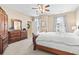 Spacious main bedroom boasts a ceiling fan, multiple windows, dresser, and a comfortable bed at 2241 Waterview Dr. # 527, North Myrtle Beach, SC 29582