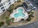 Aerial view of a community pool and outdoor seating area, with a nearby clubhouse at 2241 Waterview Dr. # 527, North Myrtle Beach, SC 29582