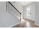 The entryway features elegant hardwood floors and a staircase with black iron railing at 227 Walnut Grove Ct., Myrtle Beach, SC 29579