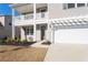 A beautiful home's exterior featuring a balcony, landscaped yard, and a charming pergola over the garage at 227 Walnut Grove Ct., Myrtle Beach, SC 29579