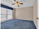 A bedroom with blue carpet, ceiling fan, and window at 268 Wraggs Ferry Rd., Georgetown, SC 29440