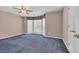 Spacious bedroom with a cozy blue carpet and a bay window for natural light at 268 Wraggs Ferry Rd., Georgetown, SC 29440