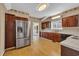 Traditional kitchen features wood cabinets, stainless steel refrigerator, and wood floors at 268 Wraggs Ferry Rd., Georgetown, SC 29440