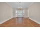 Living room with wood flooring, bay windows, and an elegant chandelier at 268 Wraggs Ferry Rd., Georgetown, SC 29440